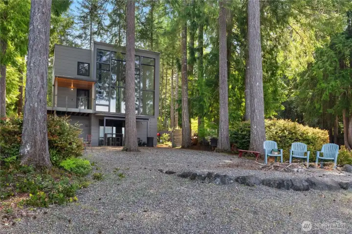 Firepit to relax aat and your home peaking through the trees.