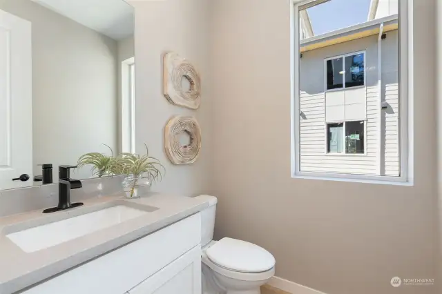 Powder bath on main level. ALL PHOTOS ARE OF OUR STAGED MODEL, FINISHES MAY VARY.