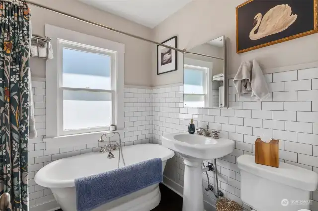 Freshly painted downstairs bathroom with historic charm.