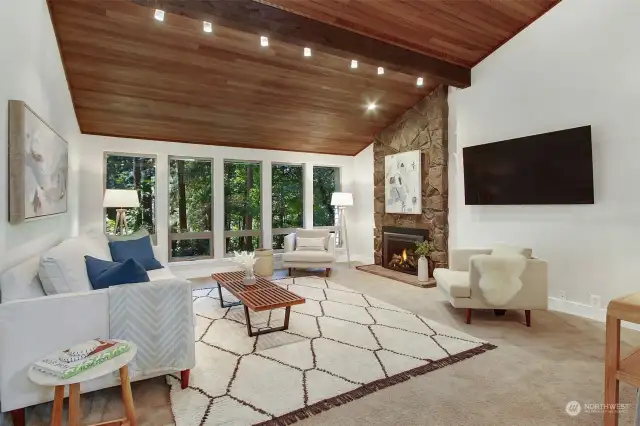Living room features vaulted Cedar ceiling and gas fireplace