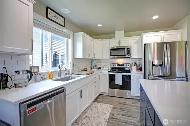 Quartz slab countertops, stainless-steel, newer appliances!