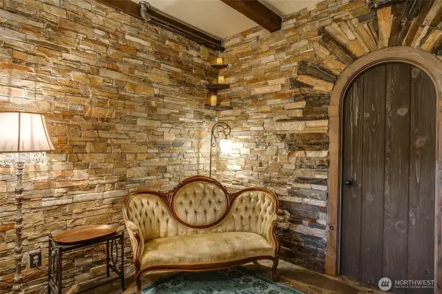 Old Rose Suite - Set in the corner of the suite is an antique, European sofa for easy viewing of the electric fireplace and flat-screen television.