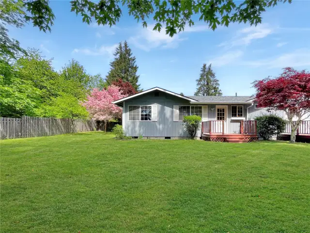 Straight on left side of house.