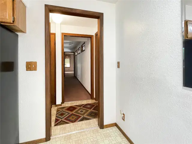 Hall way bath to left and door to garage on right