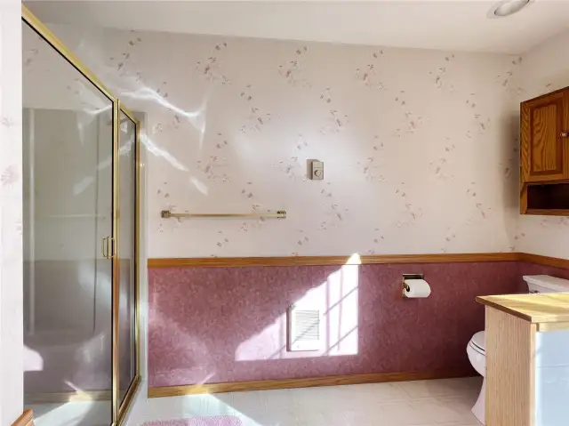 Primary bath with pony wall separating toilet.