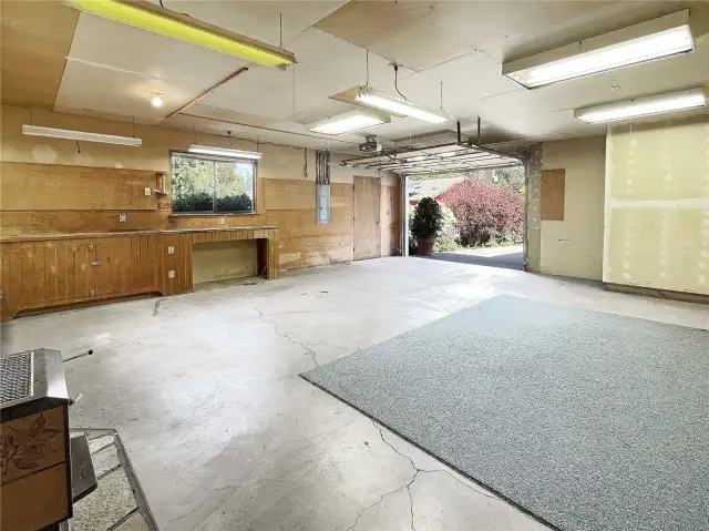 Huge garage leading up to large attic area.