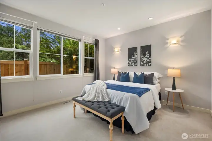 The huge primary bedroom can accommodate your preferred bedroom furniture and comes with window treatments.