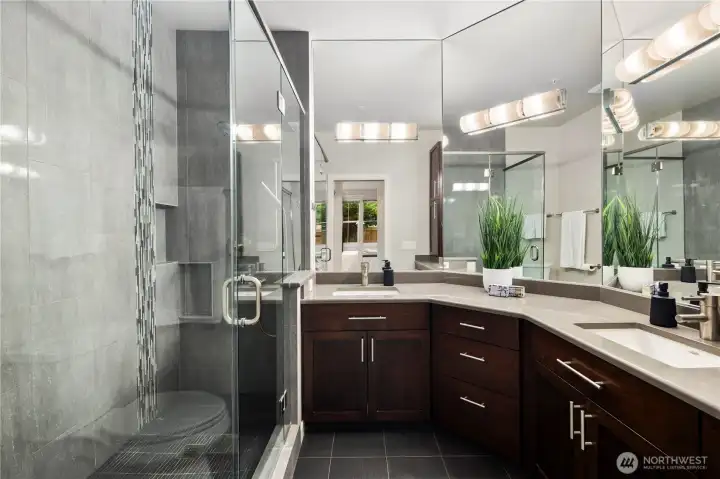 You'll never want to leave your spa-like remodeled bathroom with quartz counters, double-sinks, and huge, tiled, glass-enclosed shower.