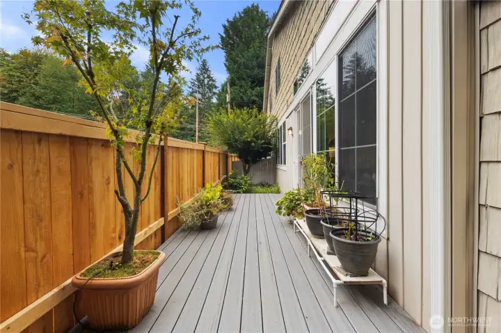 Gorgeous new fence and newer Trex decking create an inviting atmosphere for your garden with built-in watering system to keep your plants alive while you travel.