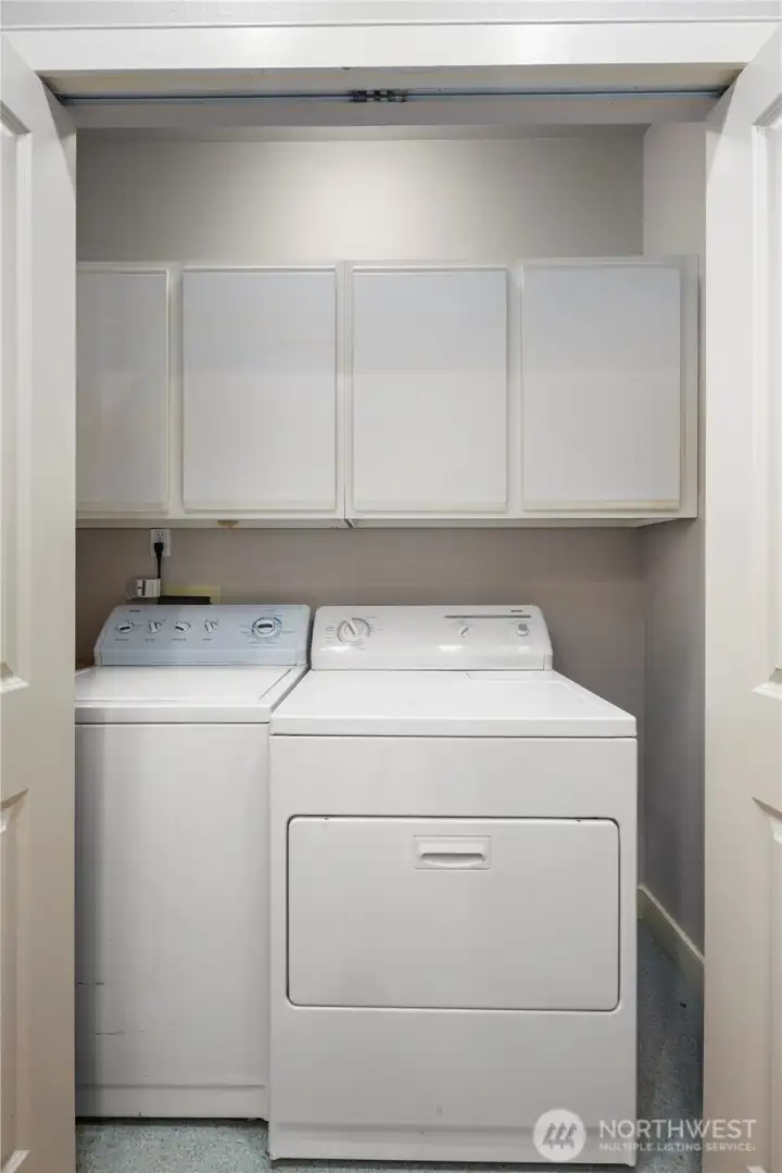 Your washer and dryer are neatly tucked away with - you guessed it - MORE storage.