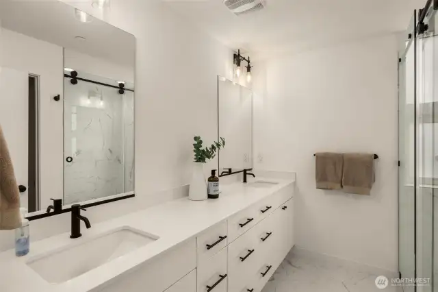 Primary ensuite features a quartz double sink vanity and a ceramic walk-in shower.