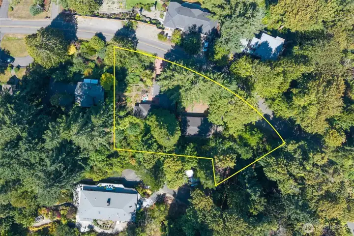 Two separate lots add up to one large parcel, shown combined in the rough estimate of the boundary lines for both lots together. The home is on one lot, with a single lower level garage, and the shop on the level second lot.