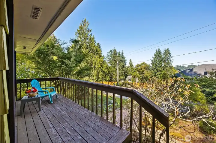 This mid-century original offers a fun front deck to view the Sunrise Beach world.  A peek-a-boo water view from the deck and front living room adds a natural accent to the lovely area.