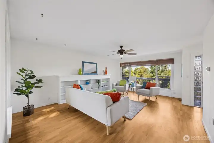 Large picture windows bring the outdoors in while the generous space leaves options for cozy evening, or big screen movie fun.  Put your ideas to work in this flexible living room.