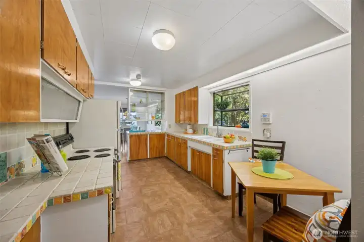Many cabinets options and built-in wall storage offer loads of room for all your kitchen gear including an opaque spice shelf with sliding doors above the range.