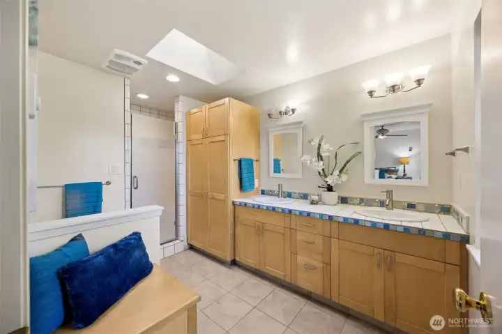 The upgraded 4-piece bath offers a wide space that is easy to maneuver in, with tile flooring and tiled step in shower.  Artisan tile accents, a large linen cabinet, skylight and view window offer special extras.