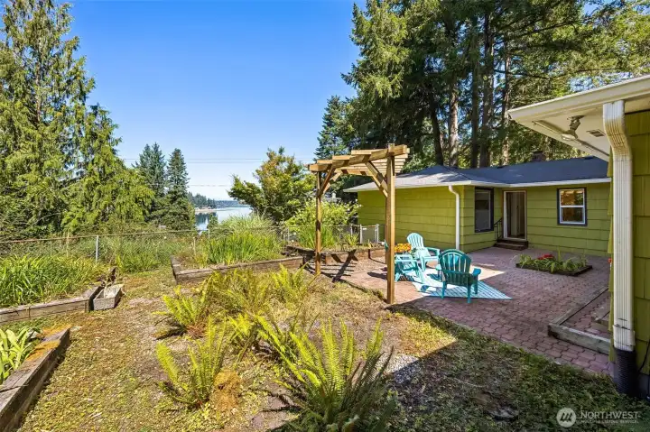 Enjoy the partial views of Eld Inlet and sunsets from the large garden area.  The small tree in the center could be, cherished as it is, or removed to open up more view.