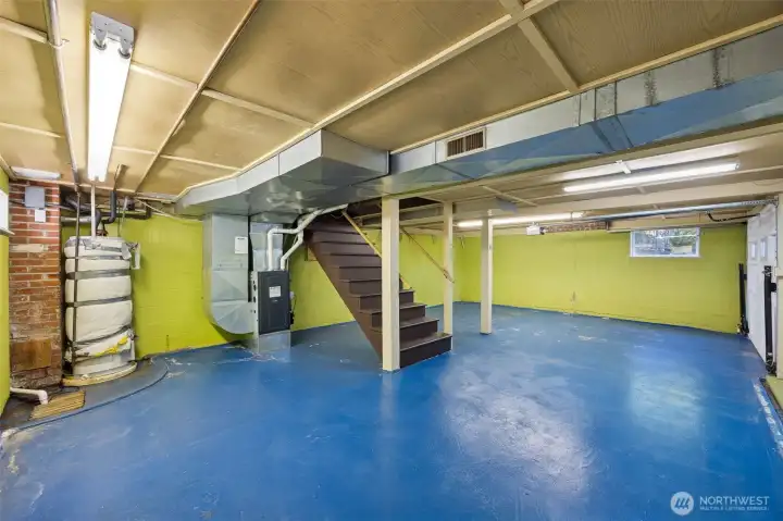 Both the garage door and stairs from the main floor level add to the mostly finished basement with daylight transom windows.  The space is designed to house a single car and hobby, or storage space too.