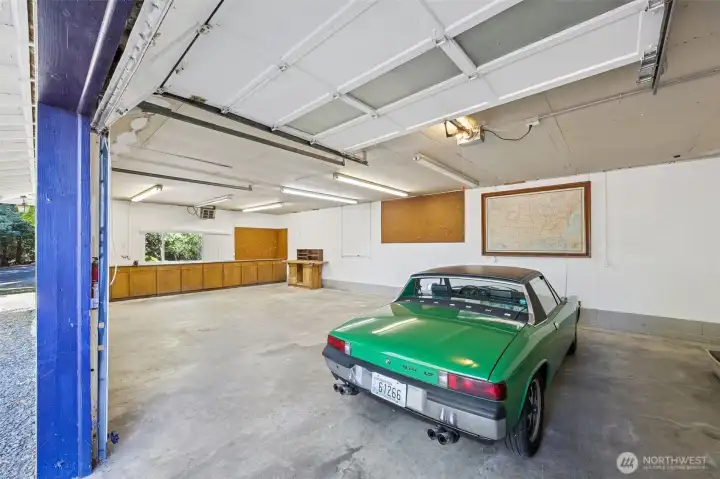 The interior of the shop shows two bay with garage doors for parking and a third bay with work space, cabinets and room for workbenches, tools, bikes, motorcycles and recreational equipment. Hard to find!