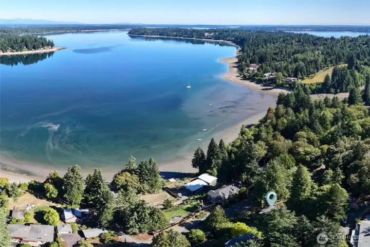 A view of the Sunset beach community with the home up on the first tier of the hillside. Public access to Eld inlet is available via the trails system at the Evergreen State College nearby. Other parks close by  too.