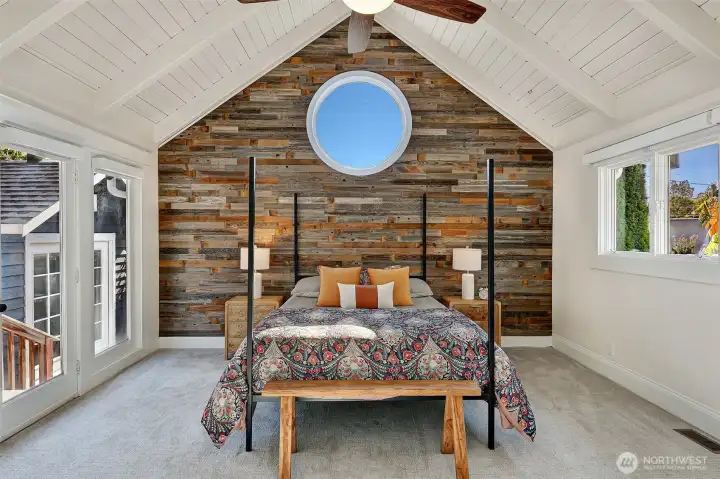 The primary retreat offers large closet spaces, vaulted ceiling, and custom accent wall.