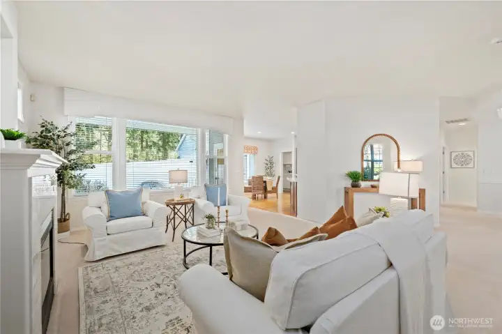A perspective highlighting how the living room flows effortlessly into the dining room and kitchen.