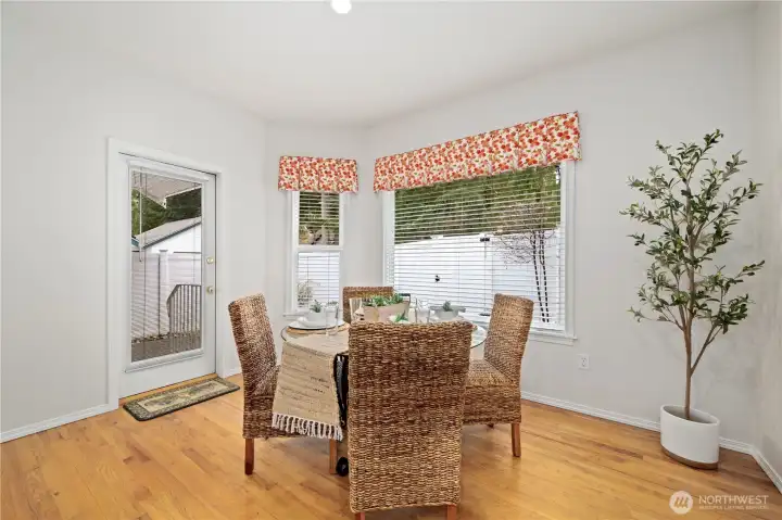 The kitchen opens to the casual kitchen eating nook, with large windows overlooking the enclosed back patio.