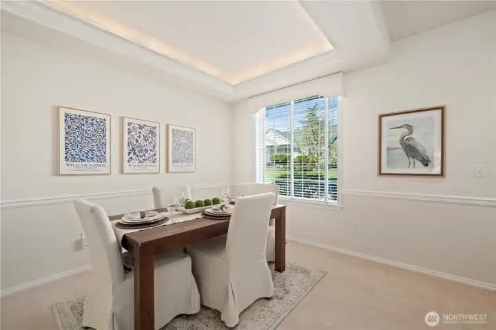 The dining room, just off the entry, features a chair rail and tray ceiling, giving the space an upscale feel.