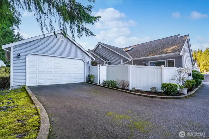 The garage is located behind the condo and   is accessed via a driveway shared with only   one neighboring owner