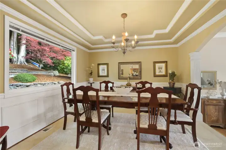 Formal dining room has tiled floor & picture window overlooking the backyard