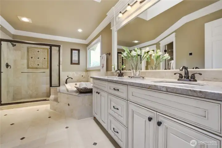 5 piece primary bathroom is finished in tile and marble