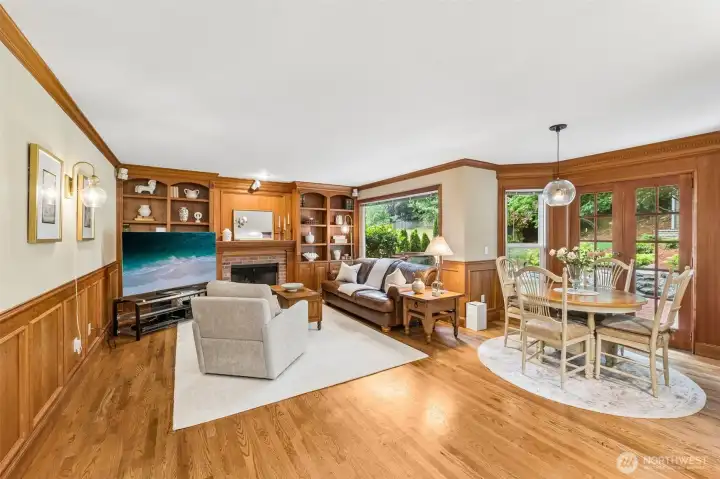 Family room has beautiful oak shelving around gas fireplace