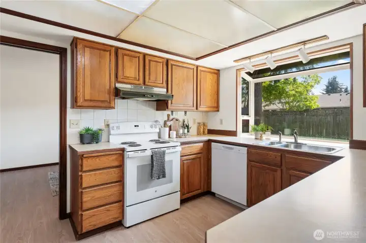 Kitchen view with a beautiful window to peek into the backyard.