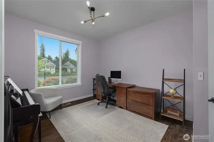 Den with double glass doors, conveniently located off entry.