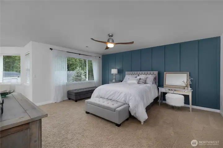 Spacious primary bedroom with sitting area.