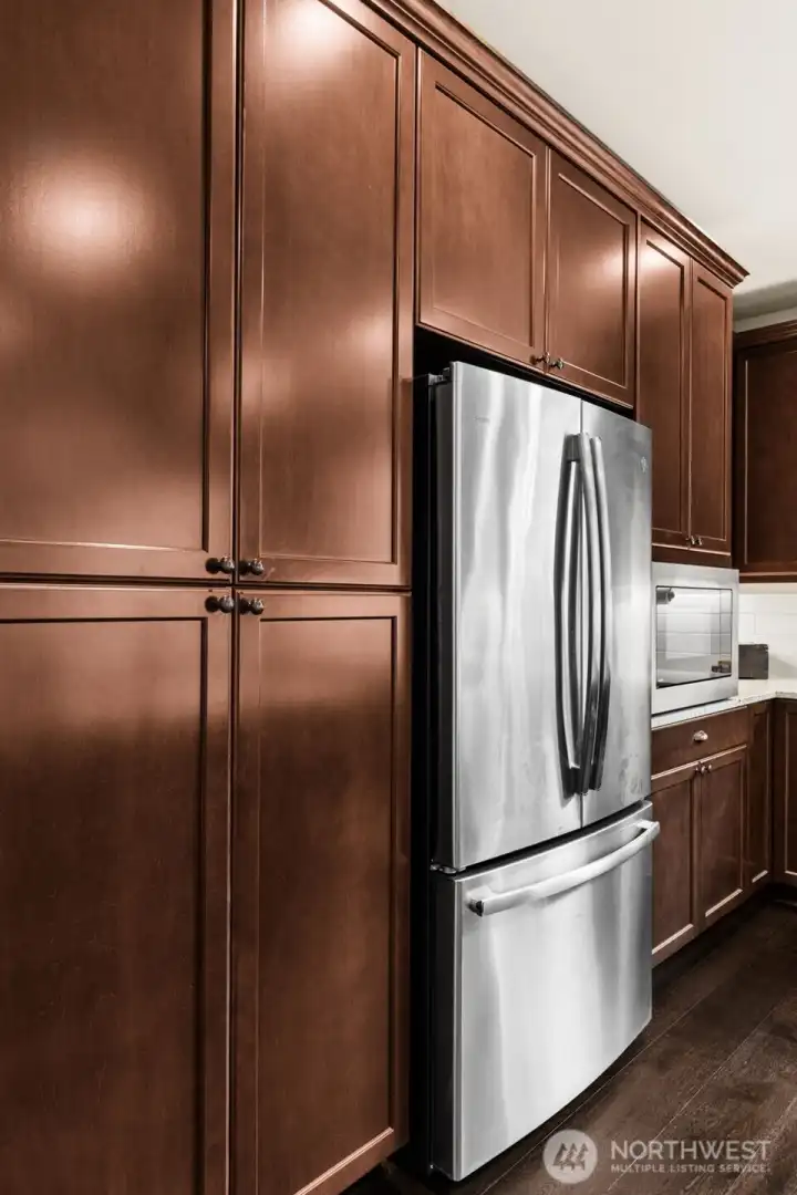 GE Profile Refrigerator surrounded by of Custom Storage with Pull-out Drawers.