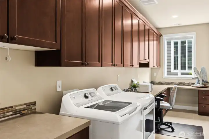 Bright Smart Space featuring Built-in Desk, Filing Cabinets, Abundant Storage and Tile Flooring.