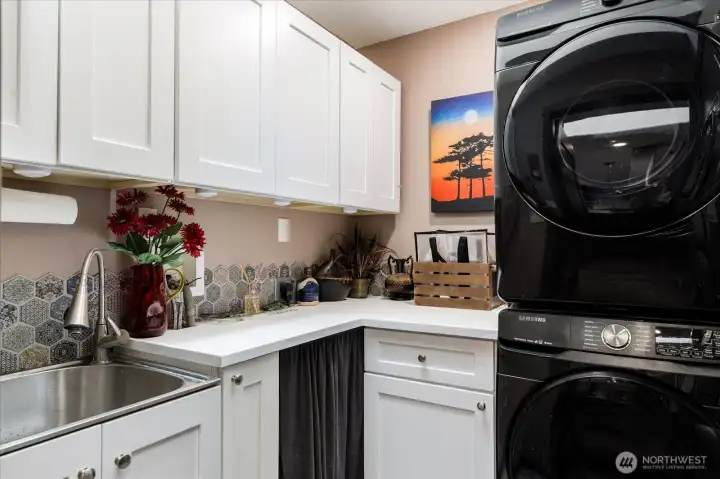 Off the kitchen is the laundry room with access to the garage. It also serves as a prep space for parties.