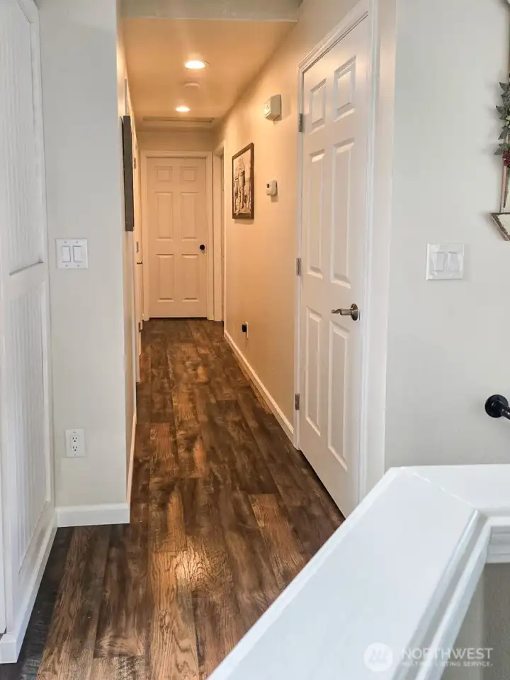 Ay the top of the stairs to the right is a hallway leading to the primary suite and two bedrooms. Ay the top of the stairs to the right is a hallway leading to the primary suite and two bedrooms.