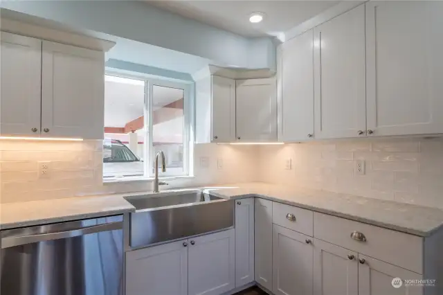 Quartz countertops and accent lighting under cabinets