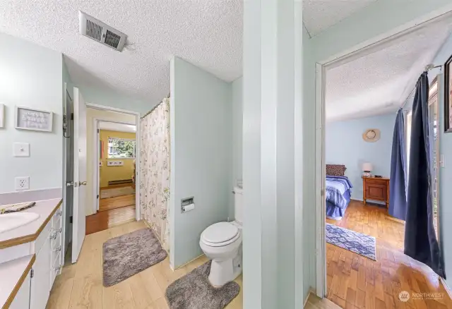 Main Bathroom with door to Primary Bedroom