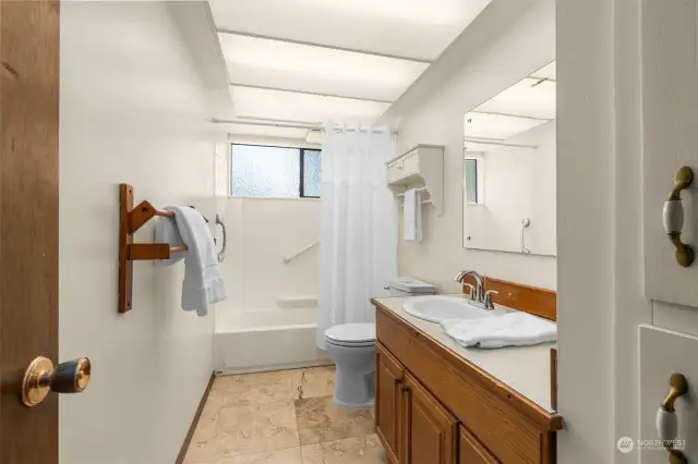 Main bathroom with tile floors and new toilet.