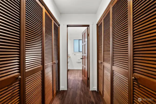 Two closet systems flanking the hallway to the bathroom provide plenty of space for storage.