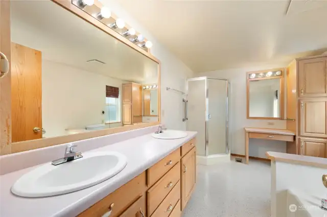 Some of the features in this ensuite bath are a double sink, separate shower, dressing table and abundant storage.