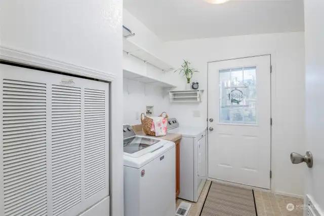 Mudroom/laundry w/shelving and additional cabinets.