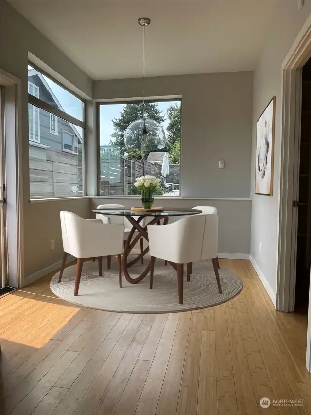 Sunny eat-in kitchen flows to the fenced yard and private patio. (Virtually staged)