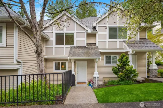 Welcome home to this two-story townhome-style condo. (Note: grass greener than it appears in person due to the magic of photo editing!)
