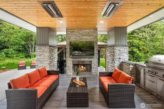 A covered patio and outdoor kitchen area make alfresco dining and entertaining effortless.