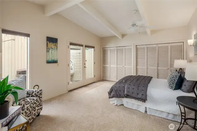 Spacious primary bedroom.   The double doors go out to the private patio and hot tub.