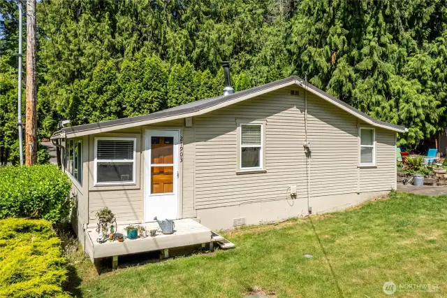 Here is a photo of the "old cabin."  It has 1 bedroom, 3/4 bath, kitchen, and family room.  It even has a mini-spit AC-Heat unit and a real wood burning stove.  The tenant is month to month but would love to enter into a new lease with the new owners.